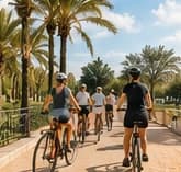 Cyclists on a sunlit greenway in Valencia