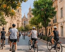 People cycling through an old-town street in Valencia